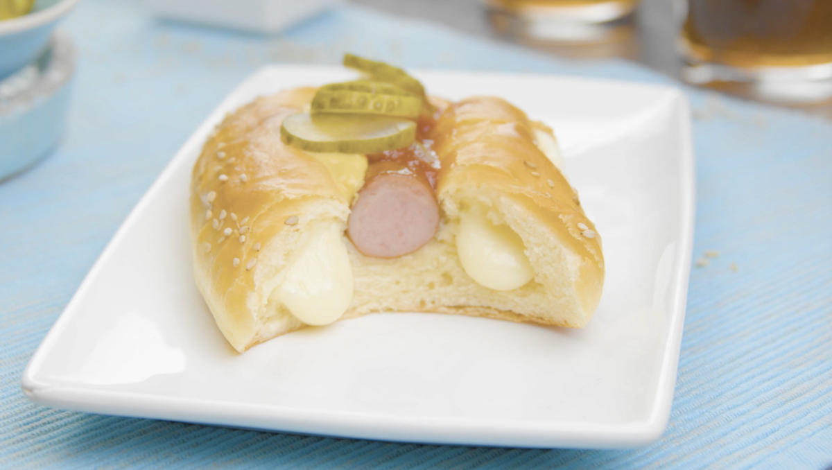 garnir le hot-dog de moutarde et de cornichons